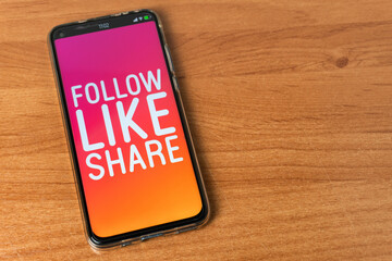 Follow Like Share - Phone on table