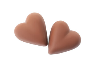 Tasty heart shaped chocolate candies on white background, top view. Valentine's day celebration