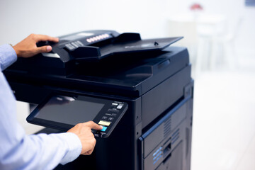 Bussiness man Hand press button on panel of printer, printer scanner laser in office copy machine supplies start concept.