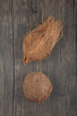 Two hairy hard coconut on wooden surface