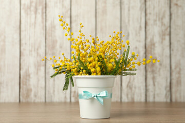 Bouquet of beautiful mimosa flowers on wooden table