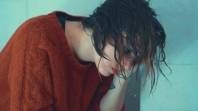 wash away sins - sad girl in remorse with her hair dripping with water