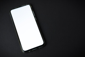 Phone with blank screen on black background