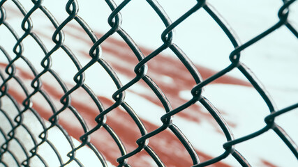 Fototapeta premium Metal chain-link fence with ice on it.