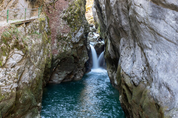 Waterfall in the Areuse gorge surrounded by steep cliffs, switzerland.