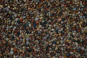 Multi colored stones on the beach. Background.