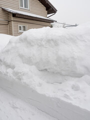 Huge heap of snow in front of the house