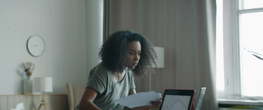 MED Black African American female working from home, having a phone call with client or office. WFH, stay home, COVID-19 coronavirus pandemic new normal concept