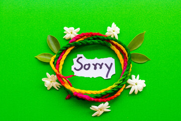 sorry message card handwriting with rope ,flowers jasmine arrangement flat lay postcard style on...