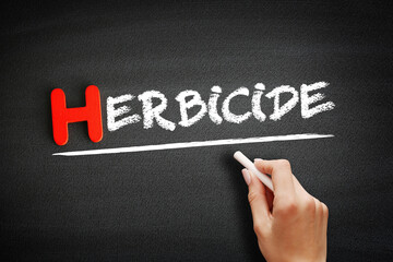 Herbicide text on blackboard, concept background