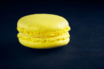 Sweet pasta of yellow color on a dark background.