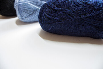 Knitting needles, colorful threads. Selection of colorful yarn wool on shopfront. Knitting background, a lot of balls. Knitting yarn for handmade winter clothes