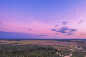 Fototapeta na wymiar Rural landscape with beautiful gradient evening sky at sunset. Aerial view