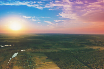 Rural landscape with beautiful colorful evening sky at sunset. Aerial view
