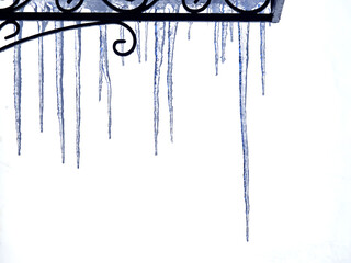 Spring. Long ice icicles hang from the roof