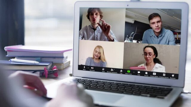 Close up view of remote employee conferencing in online group virtual chat on laptop screen. Company staff colleagues and boss using pc video call app working from home office by web cam.