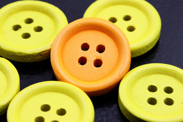 close-up colorful buttons for sewing on black background