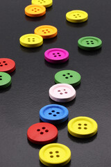 close-up colorful buttons for sewing on black background