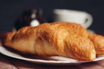 croissants saucer on the table fork with a knife fresh pastries