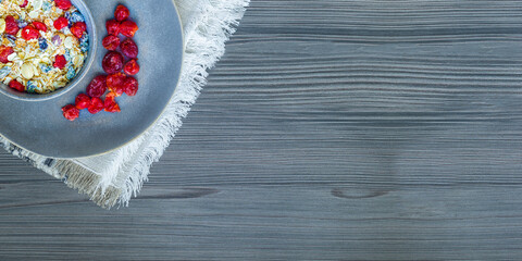 Healthy breakfast. Fresh granola, muesli with yogurt and berries on marble background. Top view. Copy space.