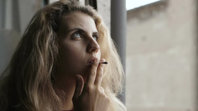faith, hope - girl smkes a cigarette looking up as if praying
