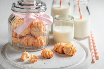 Homemade shortbread cookies in a large glass jar