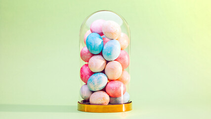 Fototapeta na wymiar Easter eggs in glass dome