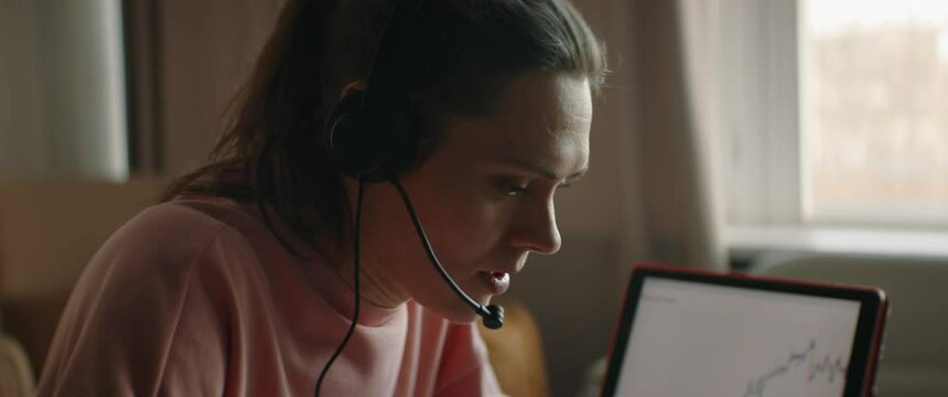 CU Portrait of Mid 30s Caucasian female working from home, having a phone call with client or colleague. WFH, stay home, COVID-19 coronavirus pandemic new normal concept