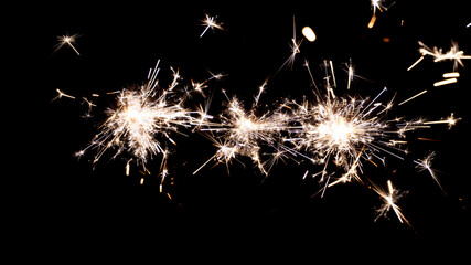 Burning sparkler on a black background. Selective focus