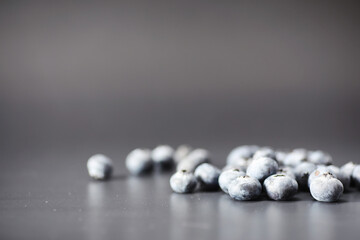 Water drops on ripe sweet blueberry. Fresh blueberries background with copy space for your text. Vegan and vegetarian concept. Macro texture of blueberry berries.