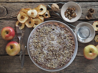 Close-up.Round homemade fruit cake on a wooden ancient table.