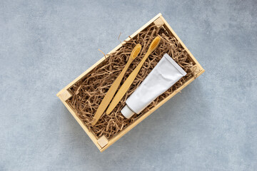 Preparing gift box set of natural eco friendly supplies for teeth. Crafting homemade gift basket. Zero waste