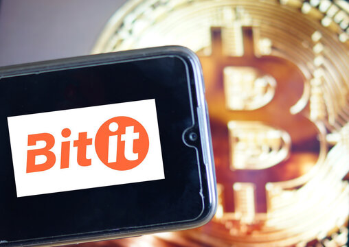 Leipzig, Germany - February 24. 2021: Closeup of mobile phone screen with logo of Bitit lettering trading platform, blurred bitcoins background (focus on center of lettering)