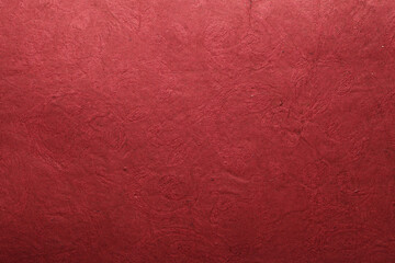 A beautiful dark red color handmade paper of wrinkle texture with veins and fibers. Useful for background, 3d rendering.