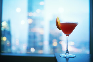 Cocktail glasses on the windowsill by the glass