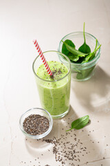 Vegetarian  green smoothie from avocado, spinach leaves and chia seeds on stone table. Selective focus