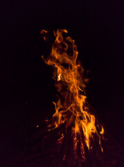 Bonfire. Large orange flame on a black background. Fire on black. Brightly, heat, light, camping, big bonfire.
