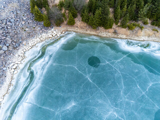 Fototapeta na wymiar Beautiful blue frozen crystal clean lake aerial drone view at early spring.