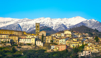 Coreglia Antelminelli village and snowy mountains on background. Garfagnana, Tuscany, Italy.
