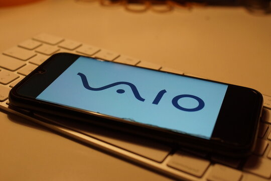 Leipzig, Germany - February 10, 2021: Closeup of smartphone screen with logo lettering of Sony vaio on computer keyboard (focus on center upper lettering)