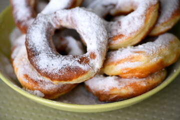 Homemade donuts with sugar on top on a plate, close up