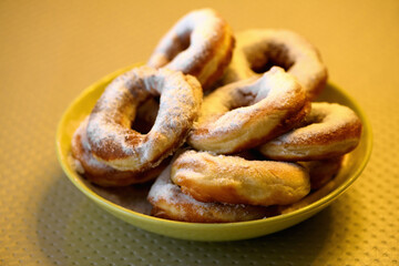Homemade donuts with sugar on top on a plate, close up