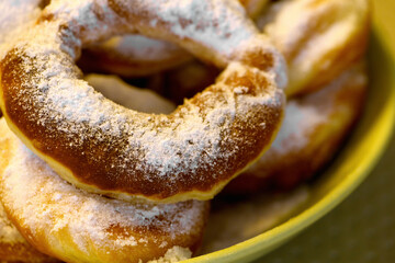 Homemade donuts with sugar on top on a plate, close up