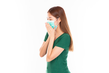 Young Asian teenage girl on white background. Casual Asian woman wearing surgical mask, corona virus (Covid-19) prevention. Casual Asian woman wearing green t-shirt over white background.