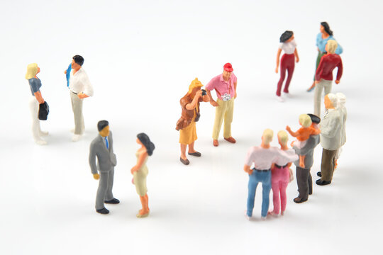 miniature people. different people communicate with each other on a white background