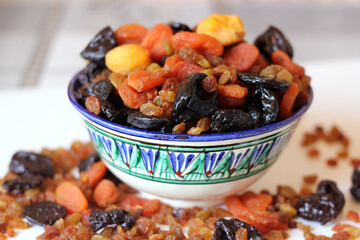 Dried fruits in a plate with oriental ornament.
