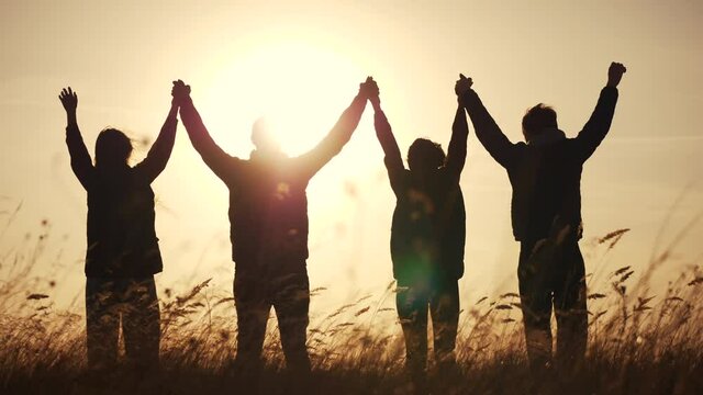 teamwork. team community hold hands together silhouette at sunset unity. group of people hands. teamwork a workers business carry out put your hands up. team in the company working partnership