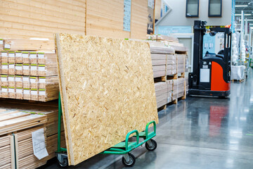 Lumber made from pressed shavings and glue. OSB sheets on a transport trolley in a building...