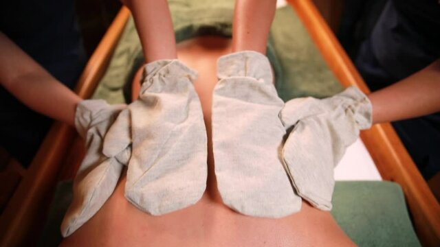 traditional Ayurvedic massage in 4 hands, performed with special mittens made of hemp.