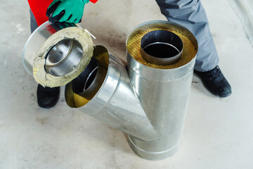 Fragment of a double stainless steel chimney with an insulating insert and a cover. Preparation for...